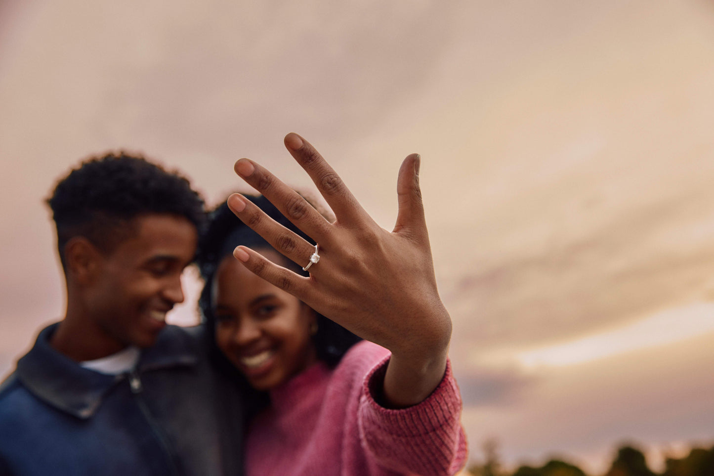 Newly engaged couple showing an engagement ring